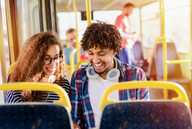 Two young people talking on the bus.